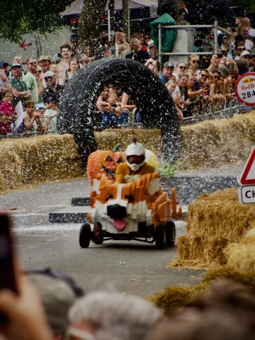 A homemade corgi soapbox kart racing downhill at Alexandra Palace in London.