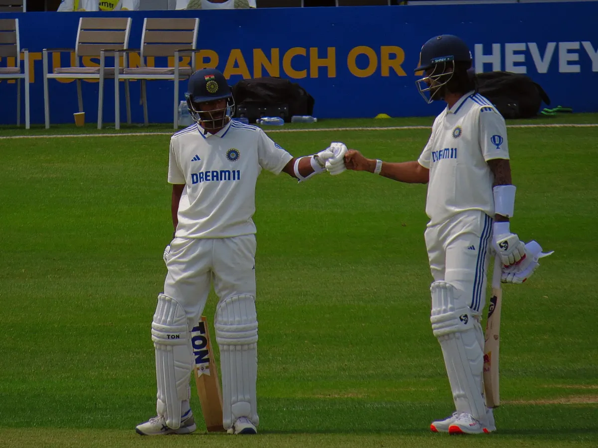 KL Rahul and Abhimanyu Easwaran fist-bump mid-pitch during a partnership at the Northampton County Cricket ground.