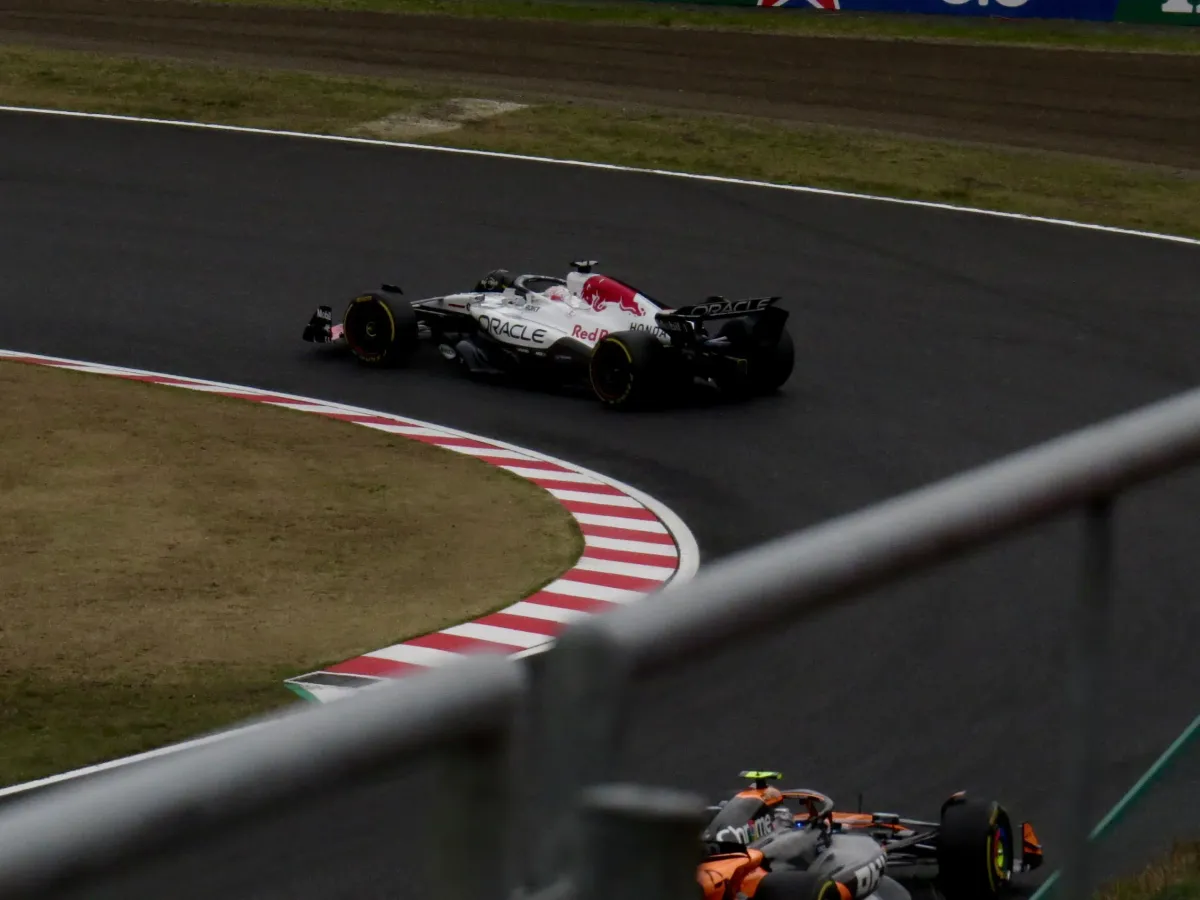 Max Verstappen in the Red Bull being chased down by McLaren's Lando Norris for the lead during the 2025 Japanese Grand Prix.