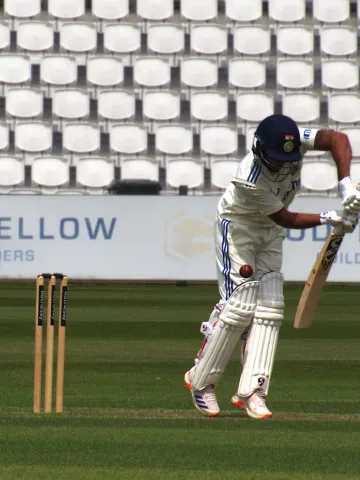 India's Nitish Kumar Reddy watchfully defends a delivery during a warm-up game against the England Lions in 2025.