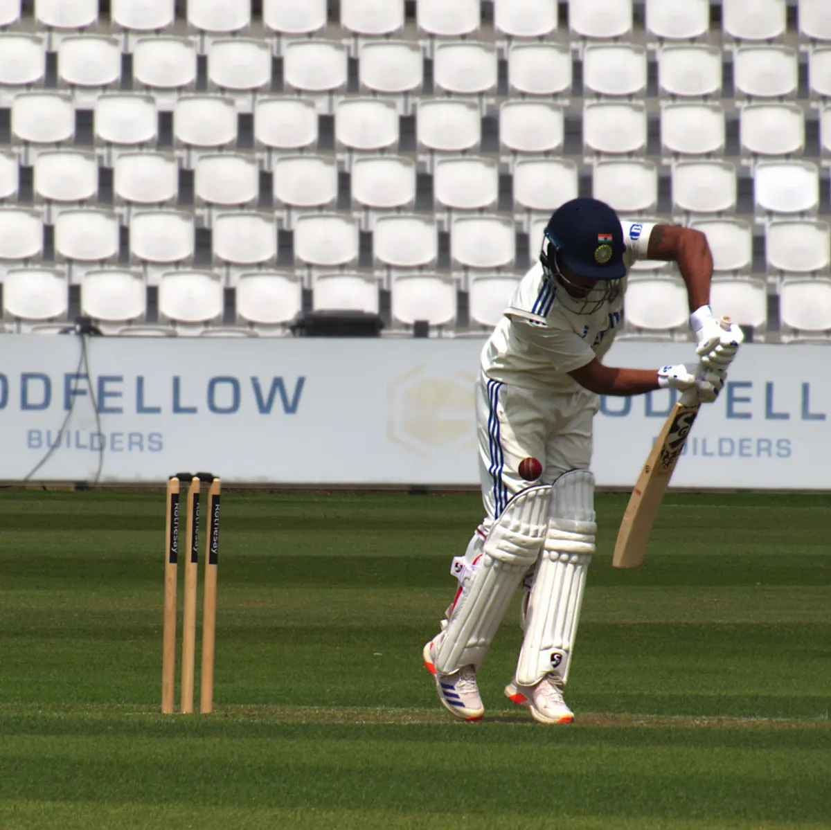India's Nitish Kumar Reddy watchfully defends a delivery during a warm-up game against the England Lions in 2025.