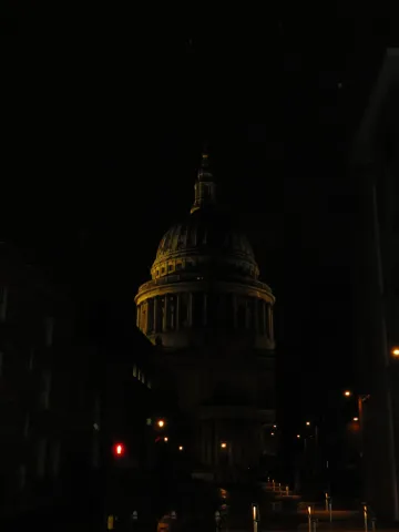 St Paul's Cathedral's dome rising above the dark London skyline at night.